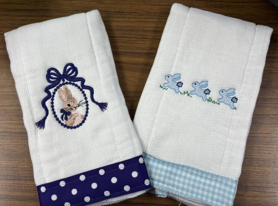 Embroidered baby burp cloths with bunny designs and polka dot and gingham ribbon trim